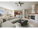 Bright, open living room with fireplace and modern decor with eat-in kitchen view creating a welcoming atmosphere at 7370 S Catawba Way, Aurora, CO 80016