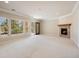 Spacious living room with fireplace, large windows and neutral carpet at 7370 S Catawba Way, Aurora, CO 80016