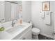Well-lit bathroom featuring a vanity, toilet, and shower with white subway tile, offering a clean and modern aesthetic at 1047 Uinta Way, Denver, CO 80230