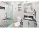 Bathroom featuring a glass-enclosed shower, modern vanity, and toilet, combining style and functionality at 1047 Uinta Way, Denver, CO 80230