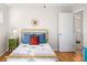 Bright bedroom with a bed featuring colorful pillows, and stylish decor, creating a cozy and inviting space at 1047 Uinta Way, Denver, CO 80230