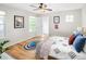 Inviting bedroom featuring hardwood floors, a ceiling fan, and plenty of natural light from the windows at 1047 Uinta Way, Denver, CO 80230