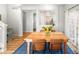 Stylish dining area with wooden table, leather chairs, chandelier, and light hardwood flooring at 1047 Uinta Way, Denver, CO 80230