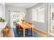 Dining area with wood table, leather chairs, bright light fixture, and sliding glass door at 1047 Uinta Way, Denver, CO 80230