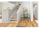 Entryway with wood floors leading to a staircase and a cozy home office nook at 1047 Uinta Way, Denver, CO 80230