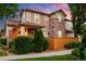 Charming home with brick accents, inviting front porch, and well-manicured landscaping at 1047 Uinta Way, Denver, CO 80230