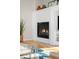 Elegant fireplace with white herringbone tile surround and a decorative mantel, adding warmth and style to the living space at 1047 Uinta Way, Denver, CO 80230