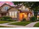 Charming home with a brick and siding exterior, manicured lawn, and a welcoming front porch, perfect for relaxing sunsets at 1047 Uinta Way, Denver, CO 80230