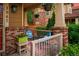 Cozy front porch with blue chairs, potted plants, and a decorative rug, creating a charming outdoor space at 1047 Uinta Way, Denver, CO 80230