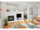 Open-concept living space with a fireplace, built-in shelving, and a view of the dining area, perfect for entertaining at 1047 Uinta Way, Denver, CO 80230