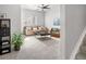 Cozy living room with neutral tones, carpeted floor, sofa, and a wicker chair, creating a comfortable and relaxing atmosphere at 1047 Uinta Way, Denver, CO 80230