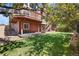 Backyard featuring patio, stairs to upper deck, lawn and mature landscaping at 11703 S Rock Willow Way, Parker, CO 80134