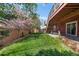 Backyard with lush lawn, mature trees, wooden fence and patio at 11703 S Rock Willow Way, Parker, CO 80134