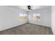 Cozy bedroom with neutral carpet, two windows, and a ceiling fan at 11703 S Rock Willow Way, Parker, CO 80134