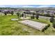 Aerial view of a community park with a basketball court, playground, and picnic area at 11703 S Rock Willow Way, Parker, CO 80134