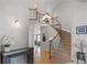 Grand foyer with a curved staircase, hardwood floors, and elegant chandelier at 11703 S Rock Willow Way, Parker, CO 80134