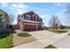 Beautiful two-story home with three car garage, a well-manicured lawn and rock landscaping at 11703 S Rock Willow Way, Parker, CO 80134