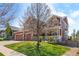 Inviting two-story home with a three-car garage, manicured lawn, and mature landscaping at 11703 S Rock Willow Way, Parker, CO 80134