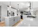 Spacious kitchen with white countertops, stainless steel appliances, large island, and wood flooring at 11703 S Rock Willow Way, Parker, CO 80134