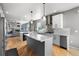 Open concept kitchen with a large kitchen island, stainless steel appliances, and views of the living area at 11703 S Rock Willow Way, Parker, CO 80134