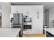 Kitchen featuring stainless steel appliances, white cabinets, and modern appliances at 11703 S Rock Willow Way, Parker, CO 80134