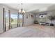 Open living room with neutral tones, large windows with scenic views, and modern lighting at 11703 S Rock Willow Way, Parker, CO 80134