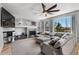 Spacious living room with a fireplace, tv, large sectional, and large windows at 11703 S Rock Willow Way, Parker, CO 80134