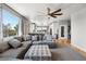 Open concept living area with comfortable seating, adjacent kitchen area, and scenic outdoor views at 11703 S Rock Willow Way, Parker, CO 80134