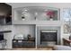 Living room with decorative fireplace, a tv, and a small sitting area at 11703 S Rock Willow Way, Parker, CO 80134