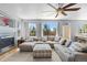 Bright living room boasts natural light, fireplace, and an oversized sectional sofa, perfect for relaxation at 11703 S Rock Willow Way, Parker, CO 80134