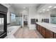 Luxurious main bathroom with double vanities, tile flooring, soaking tub, and a glass shower at 11703 S Rock Willow Way, Parker, CO 80134