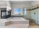 Inviting bathroom featuring a tub, fireplace, and a glass-enclosed shower for a spa-like experience at 11703 S Rock Willow Way, Parker, CO 80134
