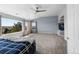 Bright main bedroom boasts a fireplace, vaulted ceilings, and large windows with neighborhood views at 11703 S Rock Willow Way, Parker, CO 80134