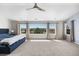 Spacious main bedroom features large windows with scenic views and a ceiling fan at 11703 S Rock Willow Way, Parker, CO 80134