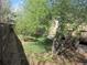 Landscaped backyard featuring grass, garden beds, a deck, and a privacy fence at 21444 E Lehigh Ave, Aurora, CO 80013