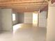 Unfinished basement space with exposed beams and concrete floor at 21444 E Lehigh Ave, Aurora, CO 80013
