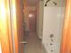 Bathroom featuring a tub and shower combo with white tile surround at 21444 E Lehigh Ave, Aurora, CO 80013
