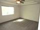 Well-lit bedroom with neutral carpet, tray ceiling with fan, offering comfort and tranquility at 21444 E Lehigh Ave, Aurora, CO 80013