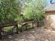 Backyard features a wooden deck with stairs surrounded by green grass and mature trees at 21444 E Lehigh Ave, Aurora, CO 80013