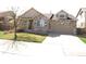 Charming two-story home featuring a stone facade, a well-manicured lawn, and an attached two-car garage at 21444 E Lehigh Ave, Aurora, CO 80013