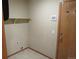 Small laundry room with shelf, outlet, and tile floor at 21444 E Lehigh Ave, Aurora, CO 80013
