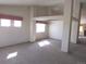 Bright and airy living area featuring plush carpet, large windows, and modern architectural support beams at 21444 E Lehigh Ave, Aurora, CO 80013