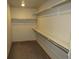 Spacious walk-in closet featuring built-in shelving and hanging rods, providing ample storage space at 21444 E Lehigh Ave, Aurora, CO 80013