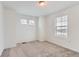 Bedroom with neutral carpet and two windows at 587 Nightsky St, Erie, CO 80516