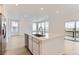 Open kitchen with stainless steel appliances and island and sliding glass door at 587 Nightsky St, Erie, CO 80516