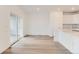 Open-concept living area with wood flooring and a sliding door at 587 Nightsky St, Erie, CO 80516