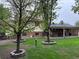 Expansive backyard featuring mature trees, a brick patio, and outdoor grilling area at 710 S Grand Ave, Fort Lupton, CO 80621