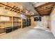 Unfinished basement offers plenty of storage space with open ceilings and shelving at 710 S Grand Ave, Fort Lupton, CO 80621