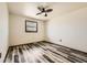 Simple bedroom design enhanced by wood-look flooring and a ceiling fan, ready for personalization at 710 S Grand Ave, Fort Lupton, CO 80621