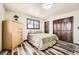Cozy bedroom with wood floors, two windows, and a spacious closet at 710 S Grand Ave, Fort Lupton, CO 80621